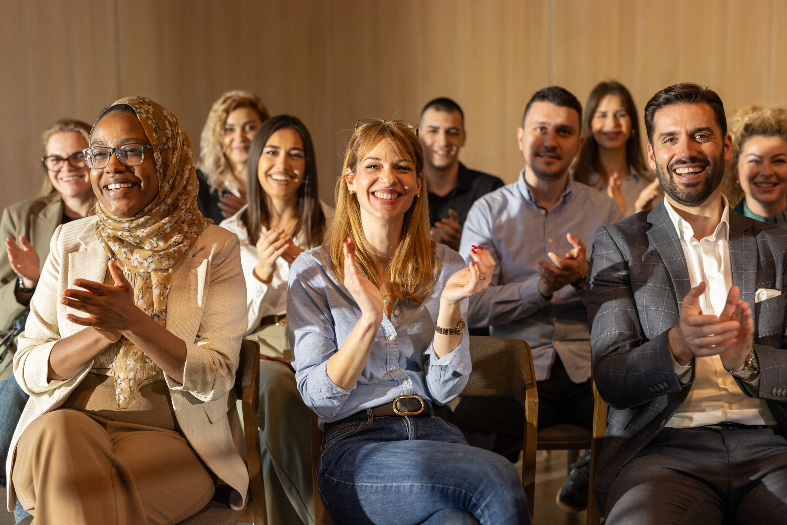 Diverse businesspeople applauding during conference